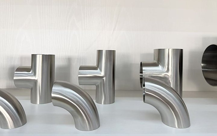 Nickel alloy elbows and tees arranged for inspection