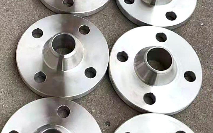 Duplex stainless flanges staged on a pallet before fabrication